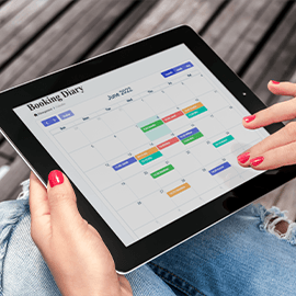 Woman looking at AltoBook diary management page on her tablet