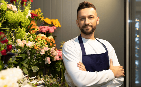 Florist sole trader next to flowers